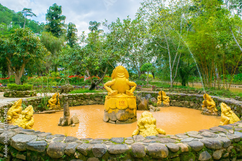 Obraz na płótnie fountain with golden frogs with coins as a Landscape design of relax tropical garden w salonie