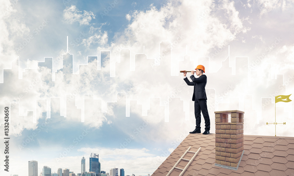 Engineer man standing on roof and looking in spyglass. Mixed med