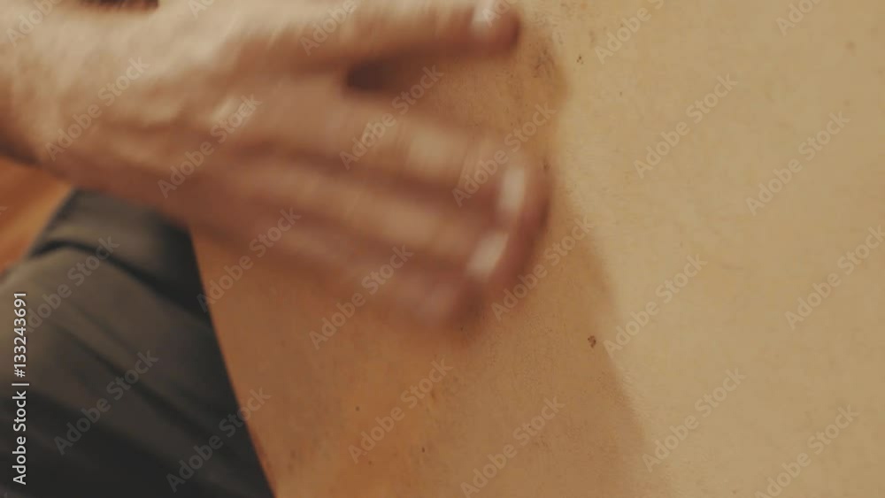 Hand of musician playing a frame drum Hand of musician playing a frame drum
