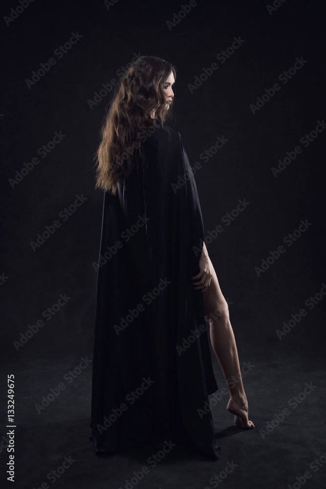 Beautiful naked gothic girl in a black cloak Stock Photo | Adobe Stock