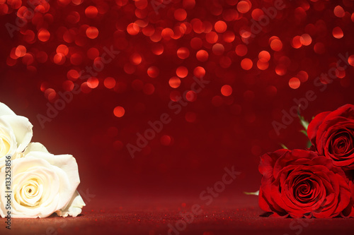 Fototapeta Naklejka Na Ścianę i Meble -  Beautiful red and white roses on sparkling red background