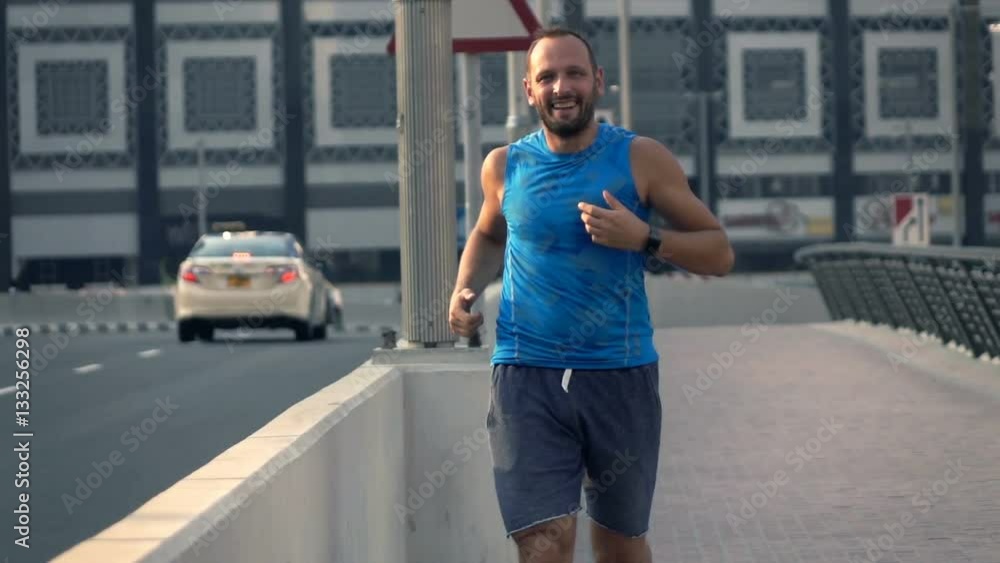 Happy, young man jogging near street in city, super slow motion 240fps
Happy, young man jogging near street in city, super slow motion 240fps