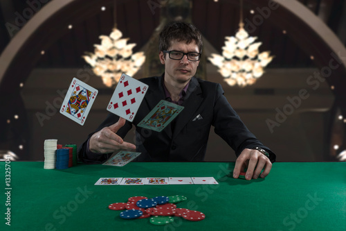 casino player in glasses playing poker