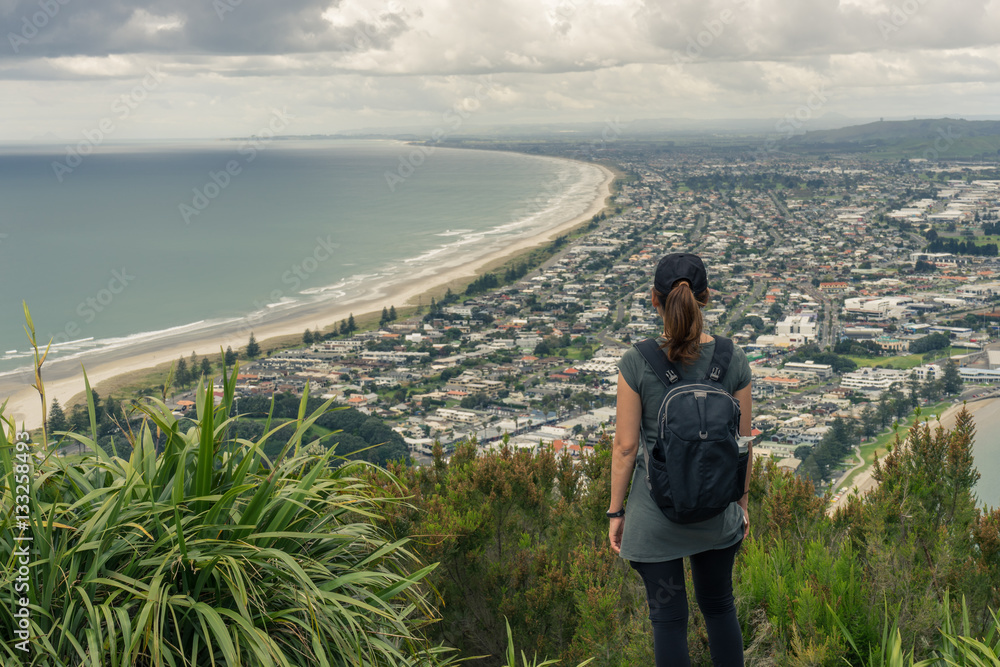 Young woman tourist enjoys the ocean view in Mt Maunganui Young woman tourist enjoys the ocean view in Mt Maunganui