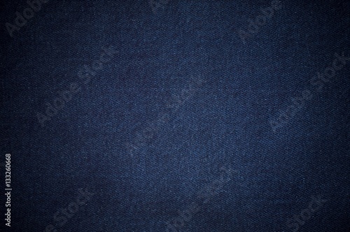 Blurry background of blue denim jeans texture.