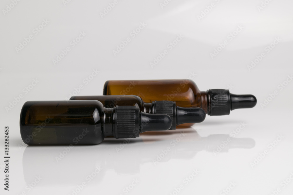 isolated drop glass bottle in brown color. isolated drop glass bottle in brown color.