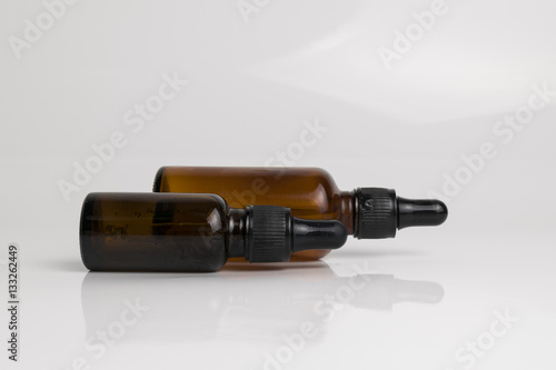 isolated drop glass bottle in brown color.