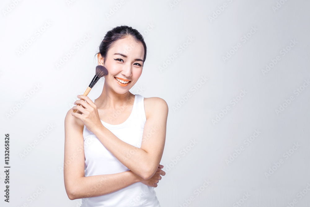 Asian woman holding brushes - beauty makeup concept Asian woman holding brushes - beauty makeup concept