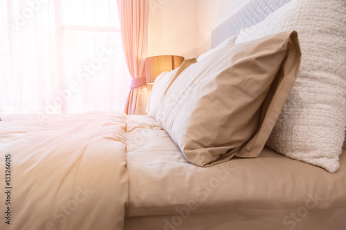 Bed maid-up with clean white pillows and bed sheets in beauty ro
