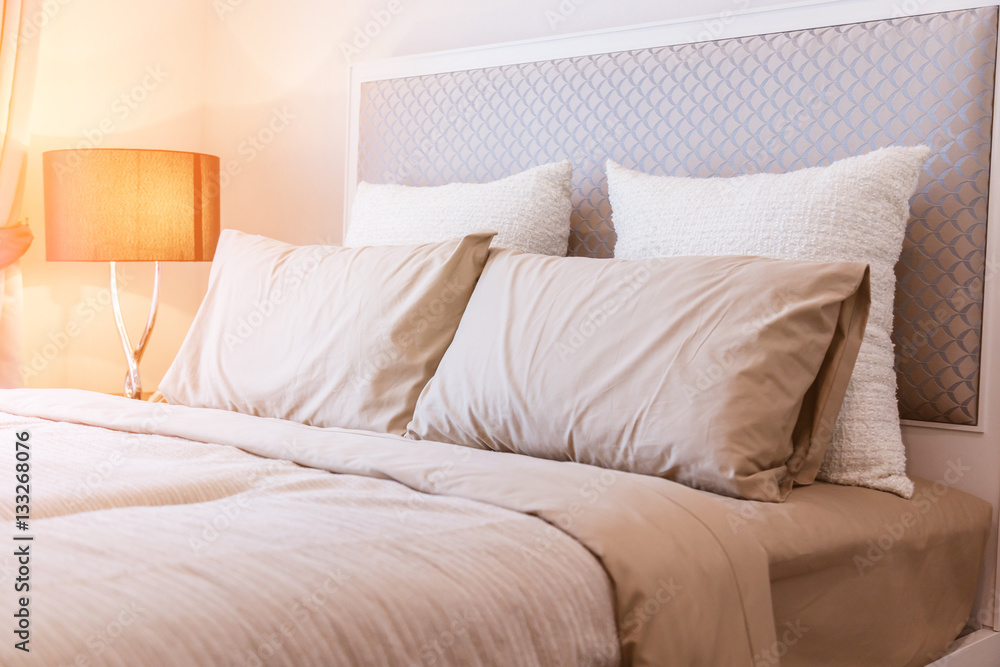 Bed maid-up with clean white pillows and bed sheets in beauty ro