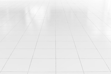 White tile floor background in perspective view. Clean, shiny, symmetry with grid line texture. For decoration in bathroom, kitchen and laundry room. And empty or copy space for product display also.