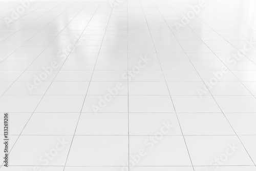 White tile floor background in perspective view. Clean, shiny, symmetry with grid line texture. For decoration in bathroom, kitchen and laundry room. And empty or copy space for product display also. photo