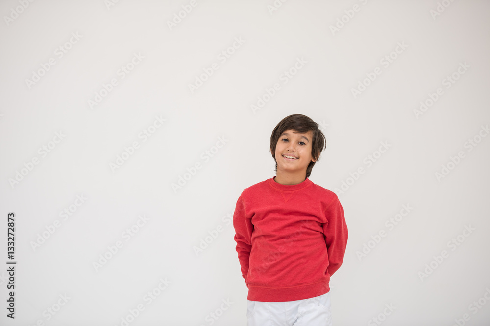 Cute school kid posing in studio with different facial expressio Cute school kid posing in studio with different facial expressio