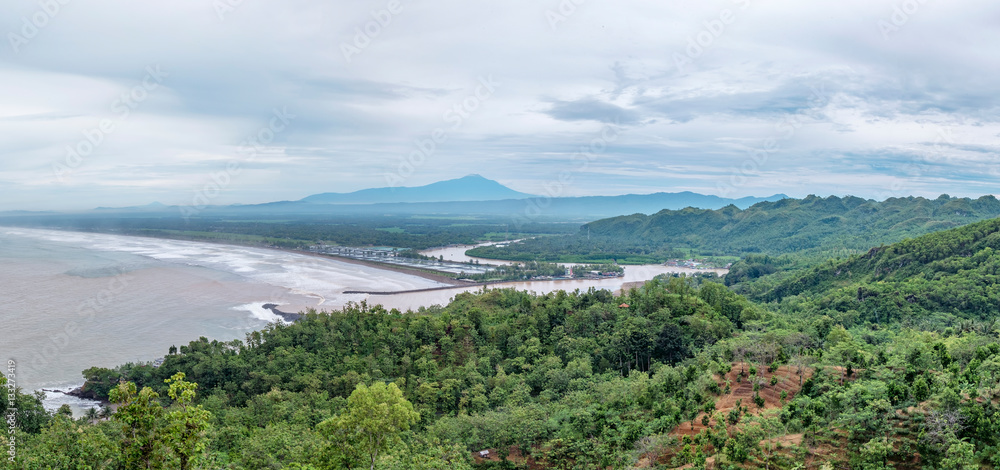 Panorama of forest, beach and mountain from top of the hill. The name of the beach is Logending, located in Kebumen, Indonesia