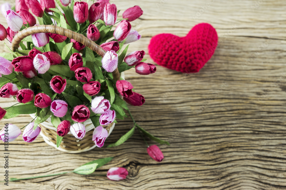 Love and valentines day concept of tulip flowers in wood basket Love and valentines day concept of tulip flowers in wood basket