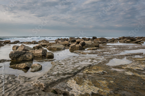 Lithified sand formations and rocks along the coastline of western Galilee