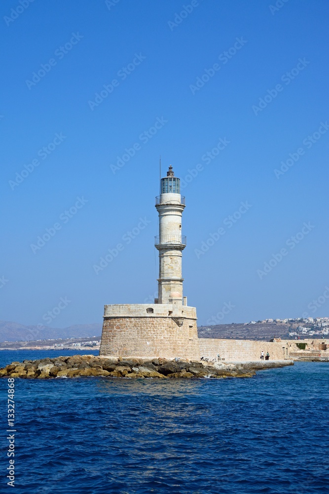 View of the Venetian lighthouse at the harbour entrance, Chania, Crete.