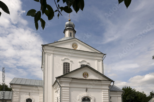 Christian orthodox white church with silver domes and gold crosses photo