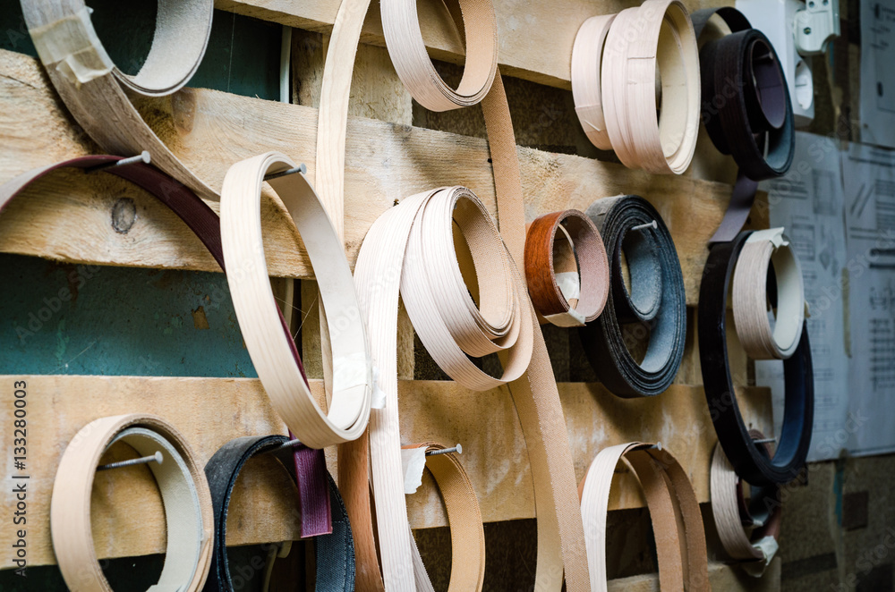 Ribbon trim chipboard on a wooden bench, furniture repair. Close-up background Ribbon trim chipboard on a wooden bench, furniture repair. Close-up background