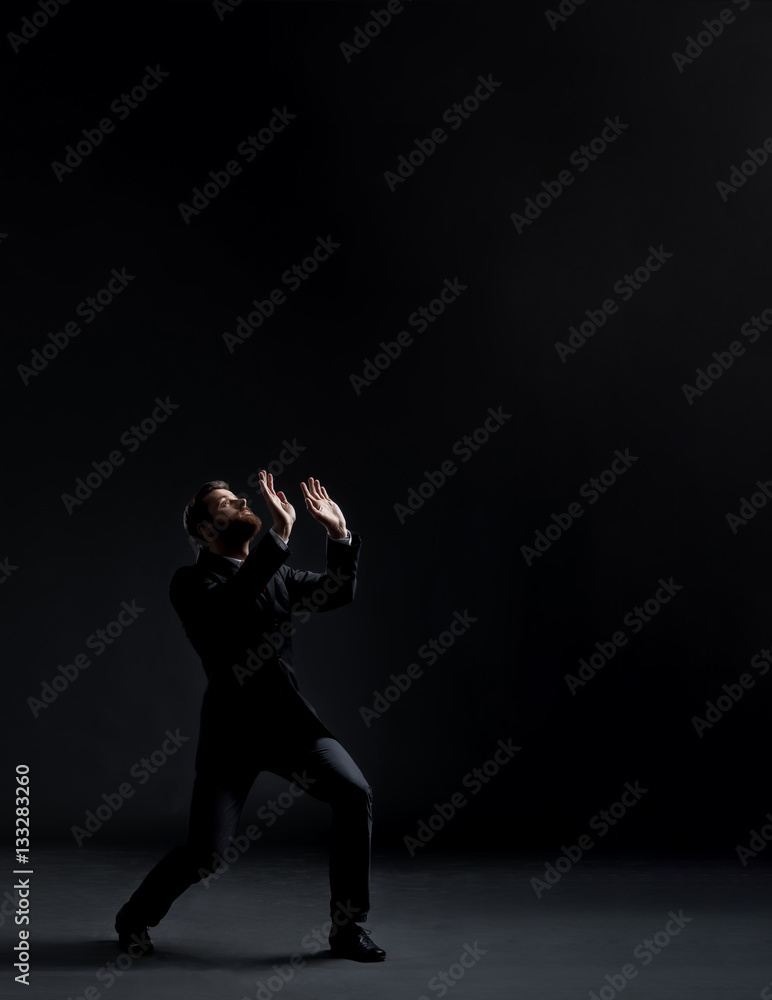 Businessman in a suit and tie pushing something