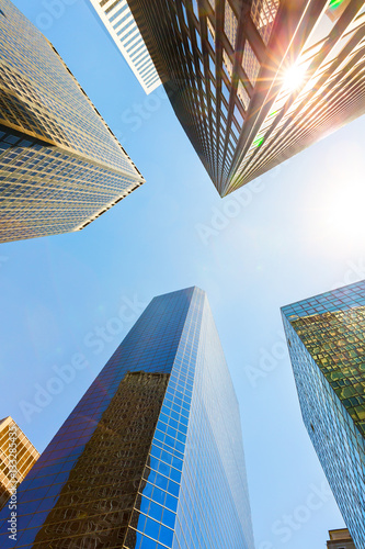 Quadro su tela Bottom view on four skyscrapers.
