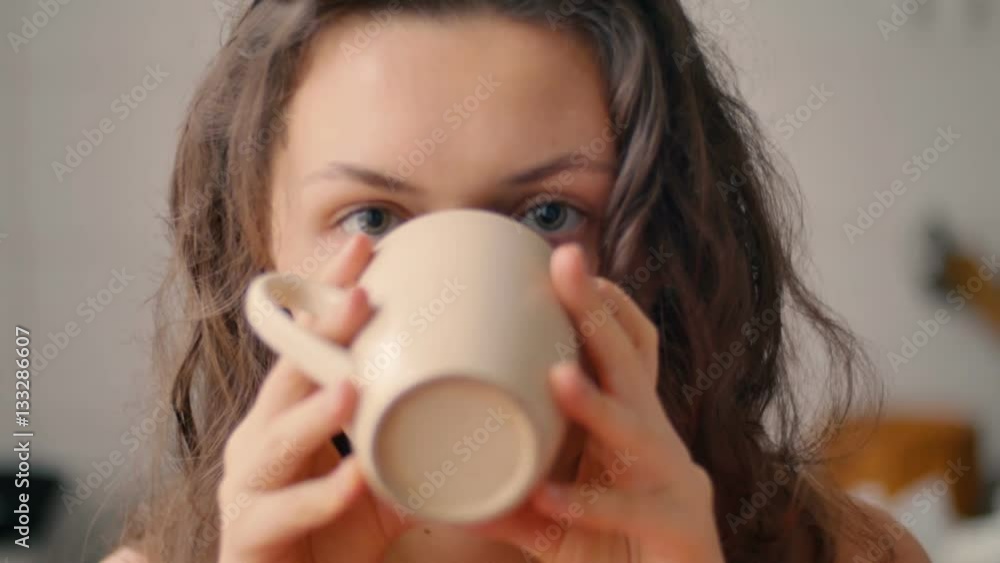 attractive smiling happy girl genuinely laugh, indulge, looking at the camera and drinks coffee attractive smiling happy girl genuinely laugh, indulge, looking at the camera and drinks coffee