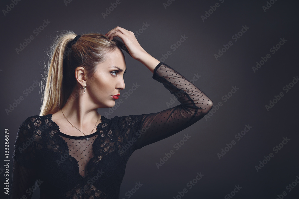 Beautiful woman posing against grey background Beautiful woman posing against grey background