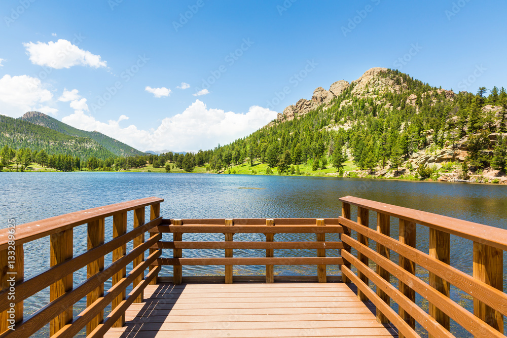 Wooden berth on lake against Rocky Mountain 