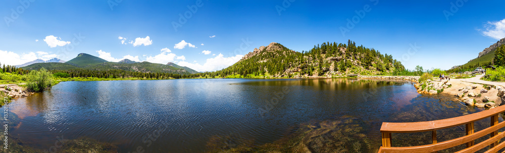 Wooden pier on lake against mountain panorama Wooden pier on lake against mountain panorama
