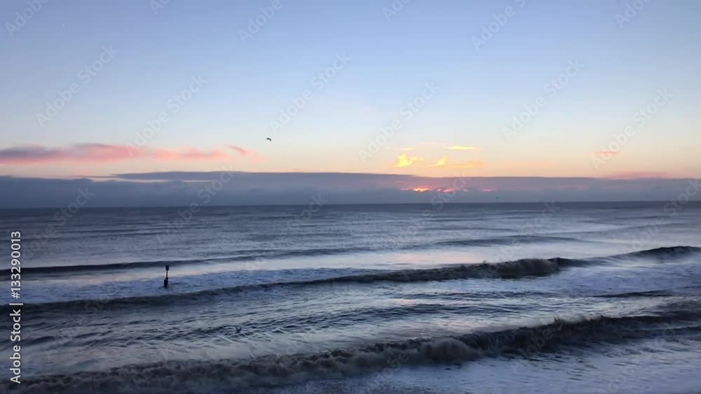 Big waves crash onto a deserted beach at sunrise High angle aerial shot in stunning slow motion Big waves crash onto a deserted beach at sunrise High angle aerial shot in stunning slow motion