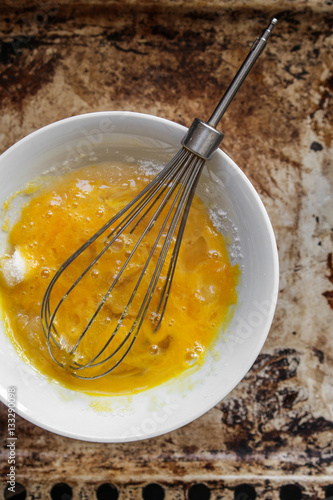 Shake the egg in a bowl, whisk