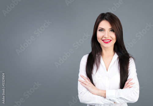 Beautiful business woman studio portrait on gray backgroung