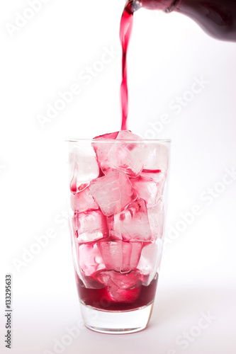 Wallpaper Mural Summer drink: Pouring fresh grapes juice on ice in glass isolated on white background Torontodigital.ca