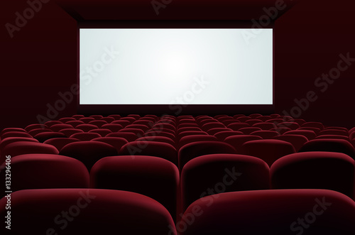 Red seats of cinema in front of blank screen
