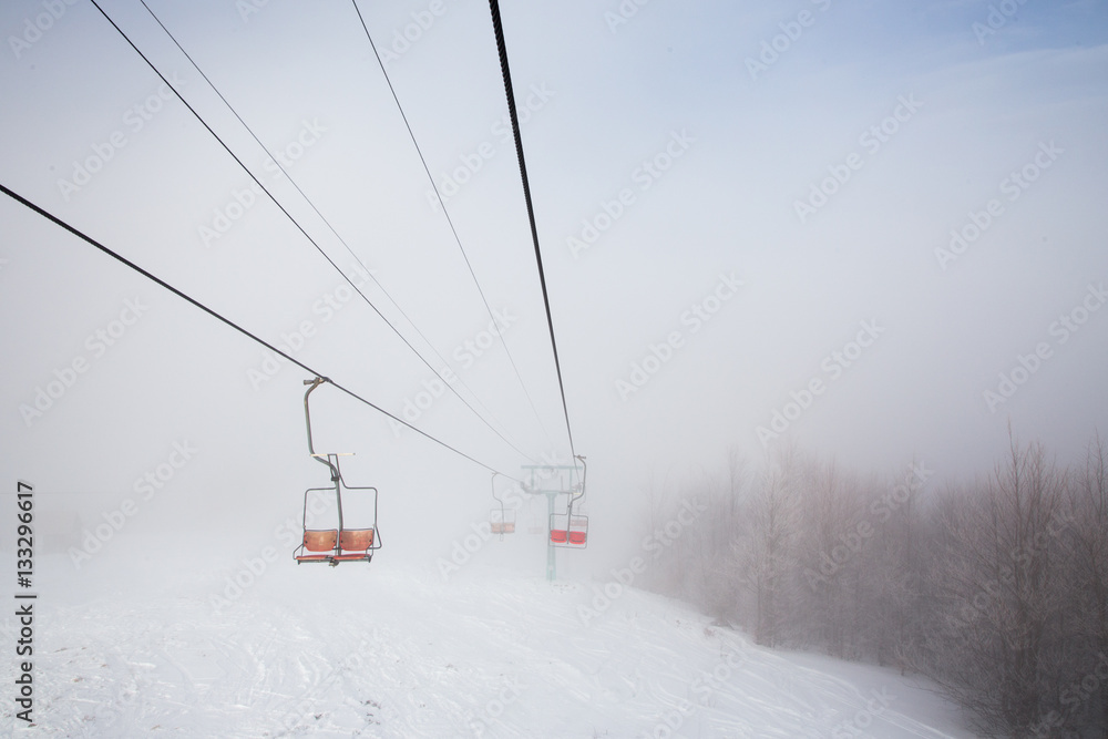 Ski lift with seats going over the mountain Ski lift with seats going over the mountain