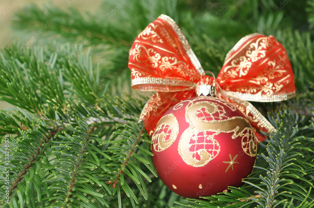 Closeup of Green Christmas tree and red ball decorations - obrazy, fototapety, plakaty 