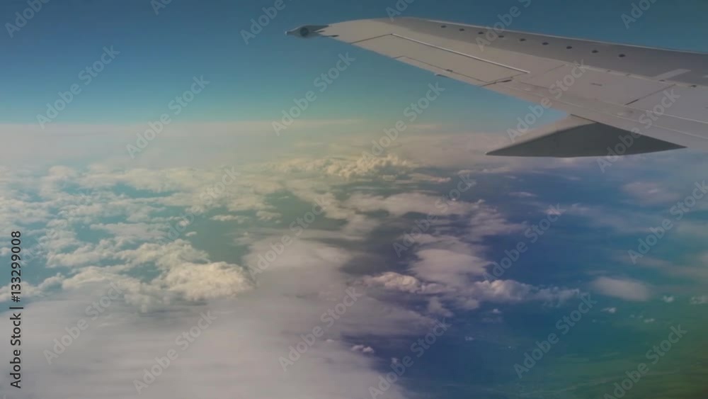 Travel by air. View through an airplane window on the cloud landscape. Travel by air. View through an airplane window on the cloud landscape.