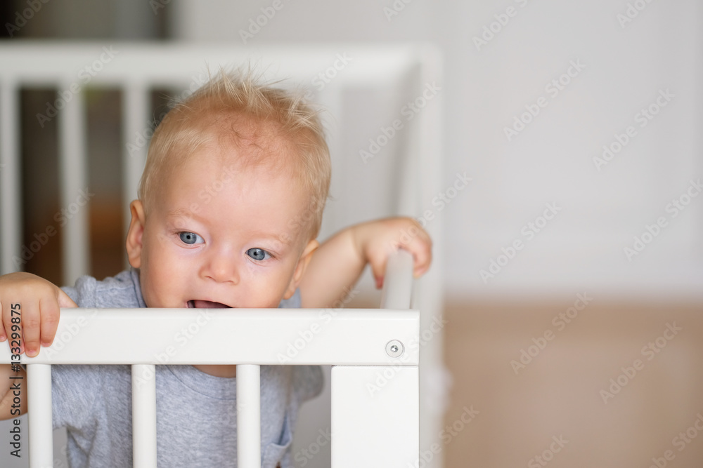 Baby boy standing in crib Baby boy standing in crib