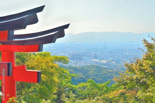 Kyoto cityscape from Inariyama mountain with a red torii gate. photo