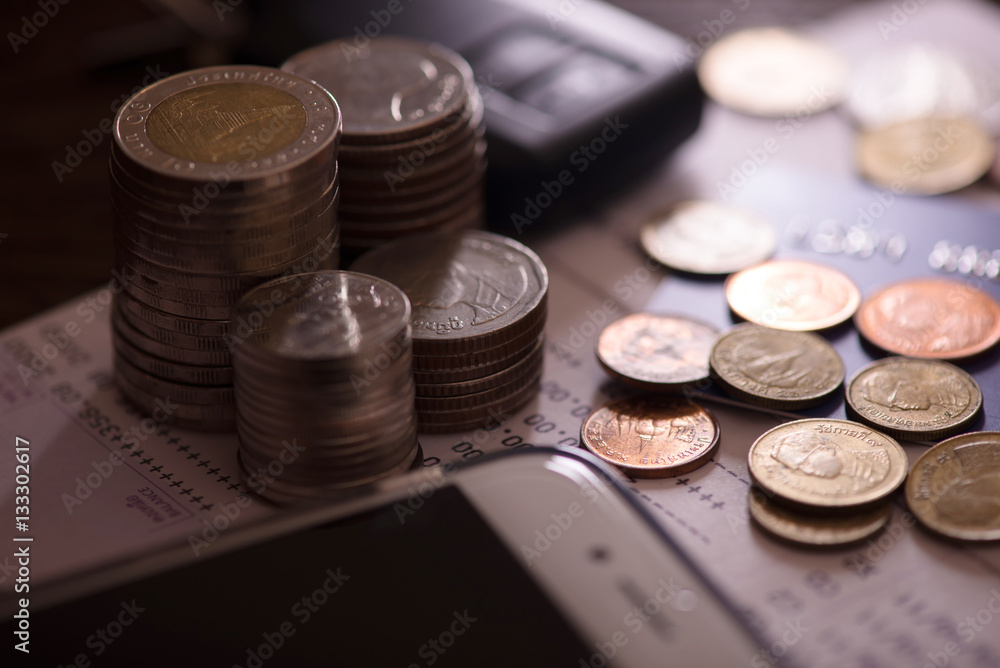 Rows of coins, account book, mobile, credit card and car key remote. Finance and banking concept. Rows of coins, account book, mobile, credit card and car key remote. Finance and banking concept.