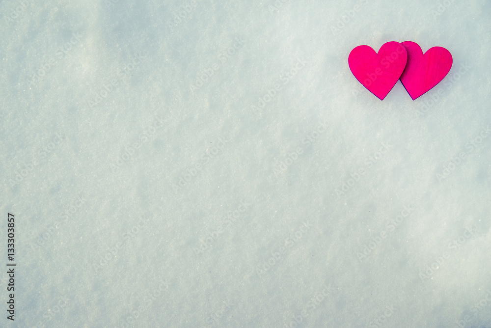 Two red hearts lie on the snow Two red hearts lie on the snow