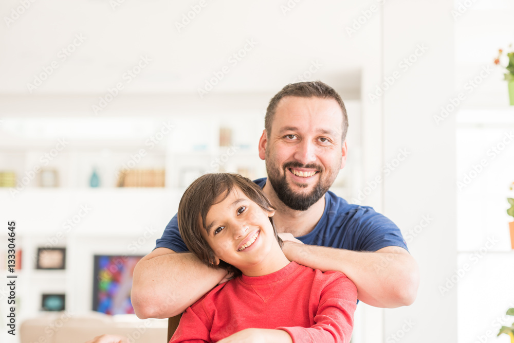 Happy father and son at modern new white home Happy father and son at modern new white home