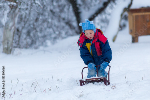 Boy with sled.