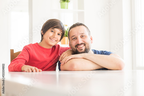 Happy father and son at modern new white home