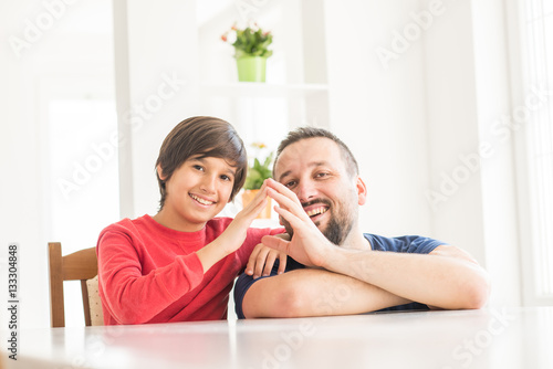 Happy father and son at modern new white home