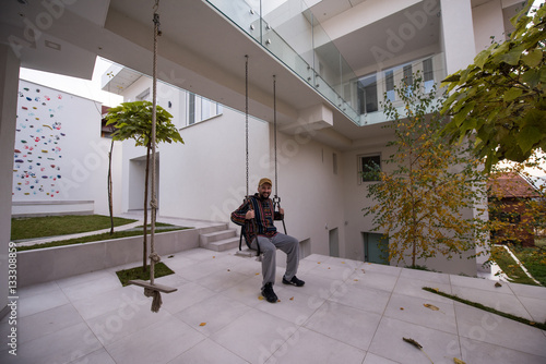 Man living his dream in front of his new modern house © Jasmin Merdan
