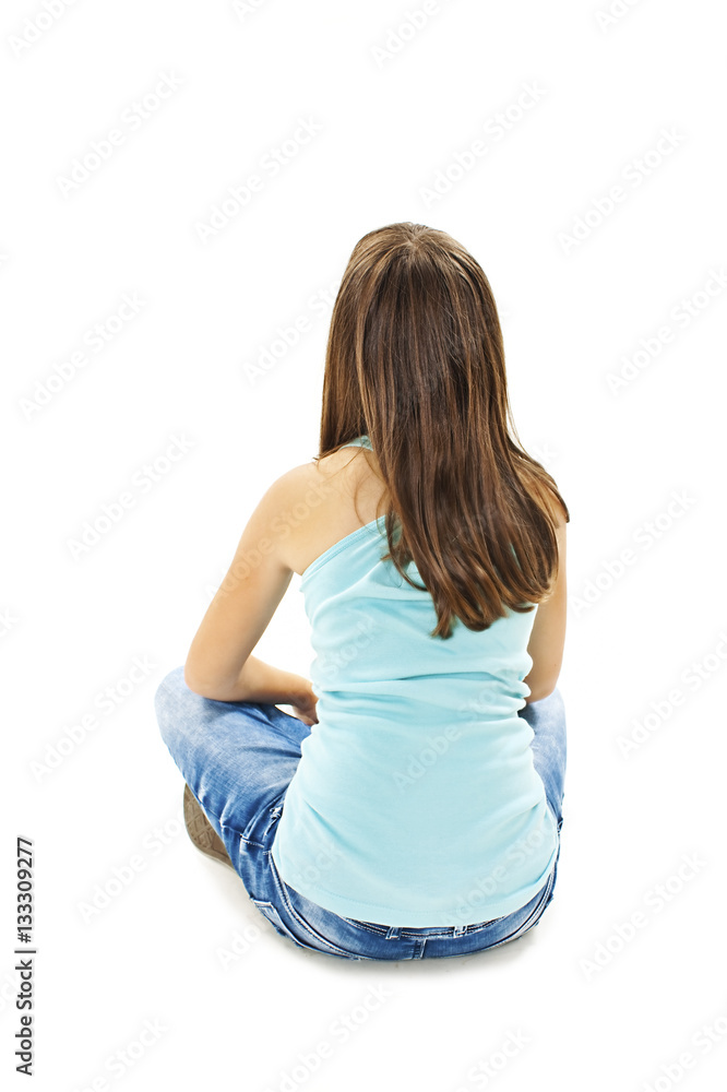 Rear view of little girl sitting on floor. Isolated on white background ...