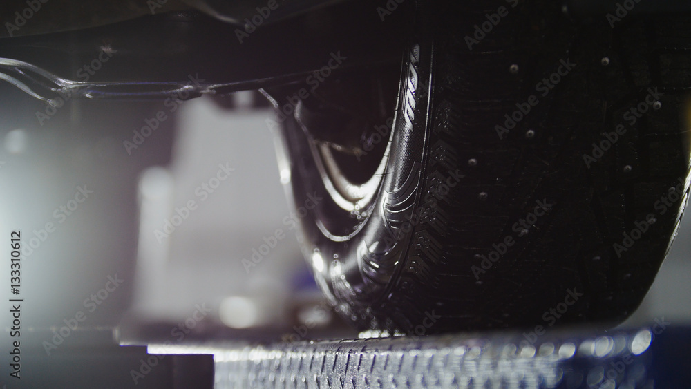 Fototapeta premium Auto wheel alignment in service, car preparing for professional diagnostics, close up