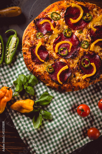 Fresh and tasty homemade pizza on wooden table with ingredients