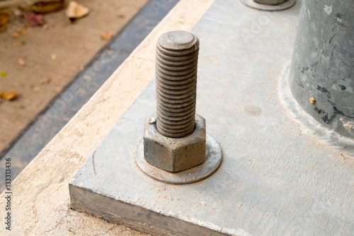 Bolt and nut at a utility pole base